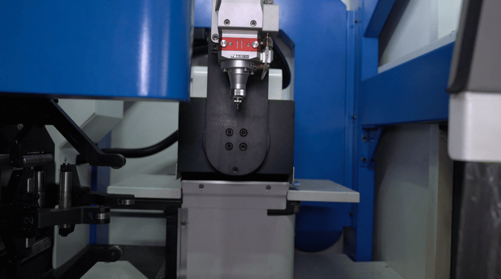 Close-up of a Baison automated laser welding head setup inside a machine