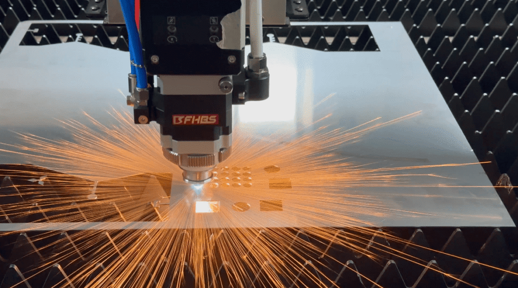 Worker wearing white gloves inspecting a precision laser-cut metal corner joint
