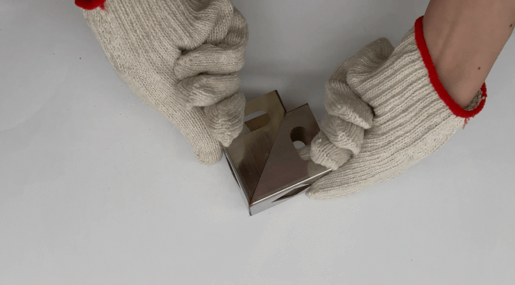 CNC laser cutting machine head creating intricate patterns on metal plate