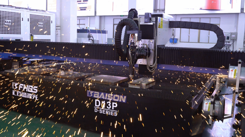 BAISON D13P laser cutter operating in a workshop, with a shower of golden sparks flying