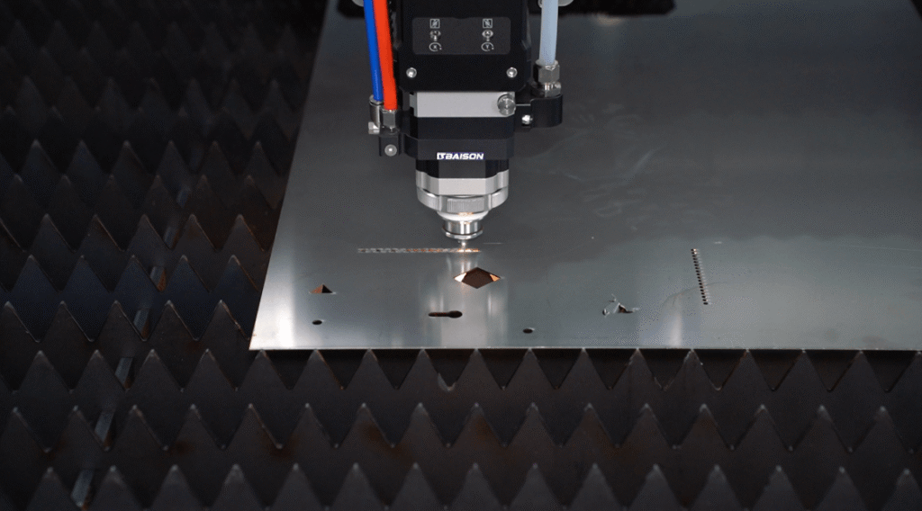 Baison fiber laser cutting machine with sparks on sheet metal.