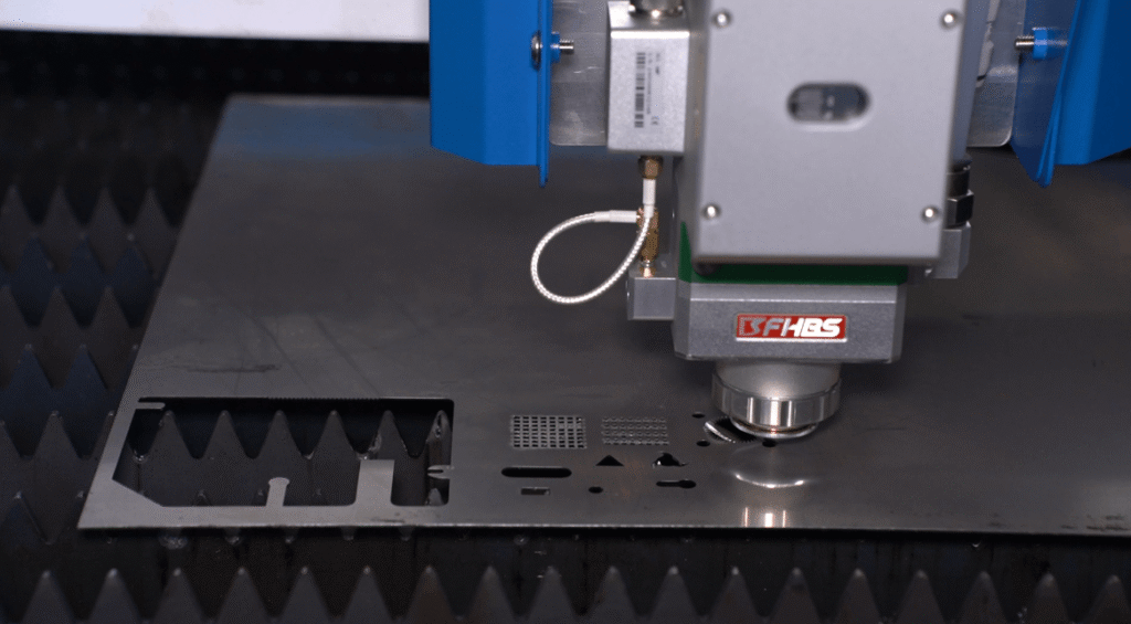 Laser cutting head with negative focus cutting stainless steel sheet.