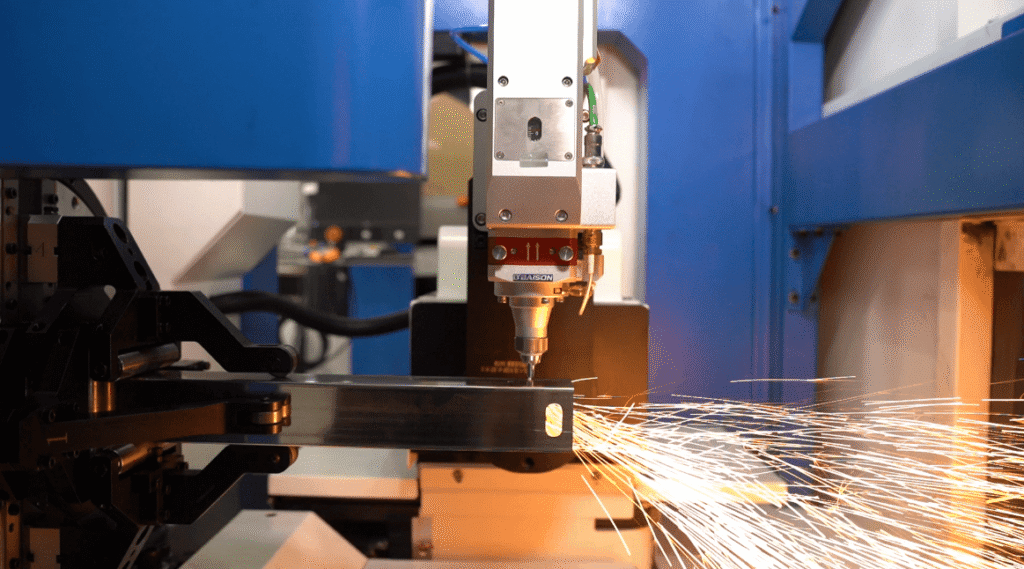 Laser cutting machine executing a speed ladder test with sparks.
