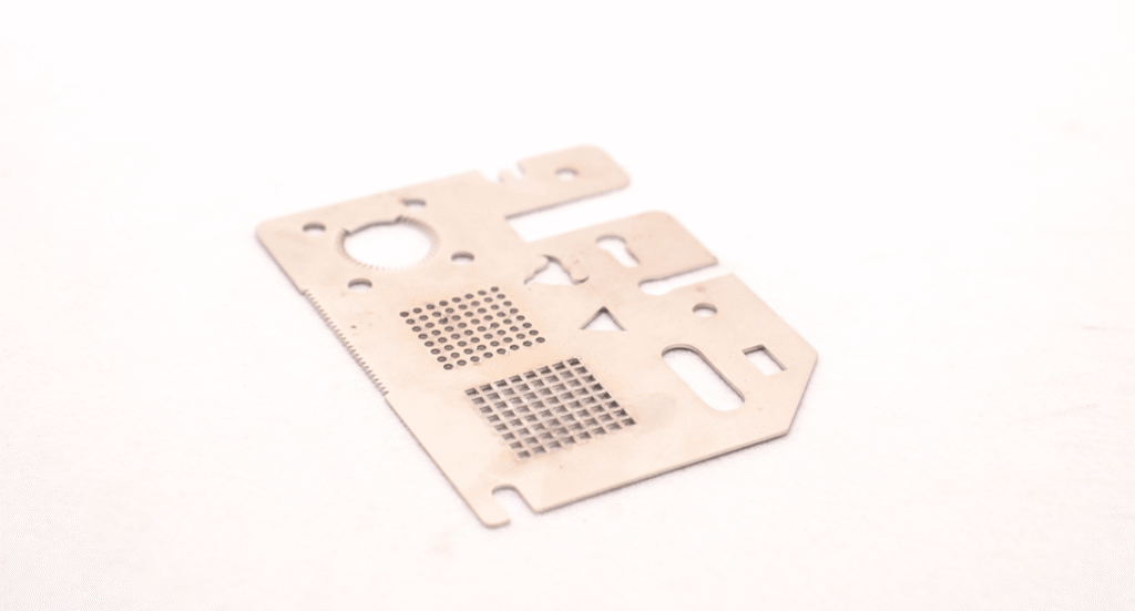Laser cutting rotary attachment processing a square metal tube.