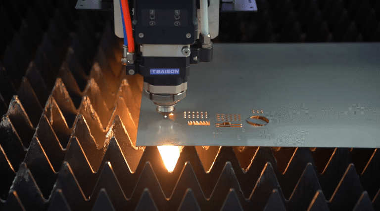 Baison fiber laser head cutting metal sheet with bright orange sparks.