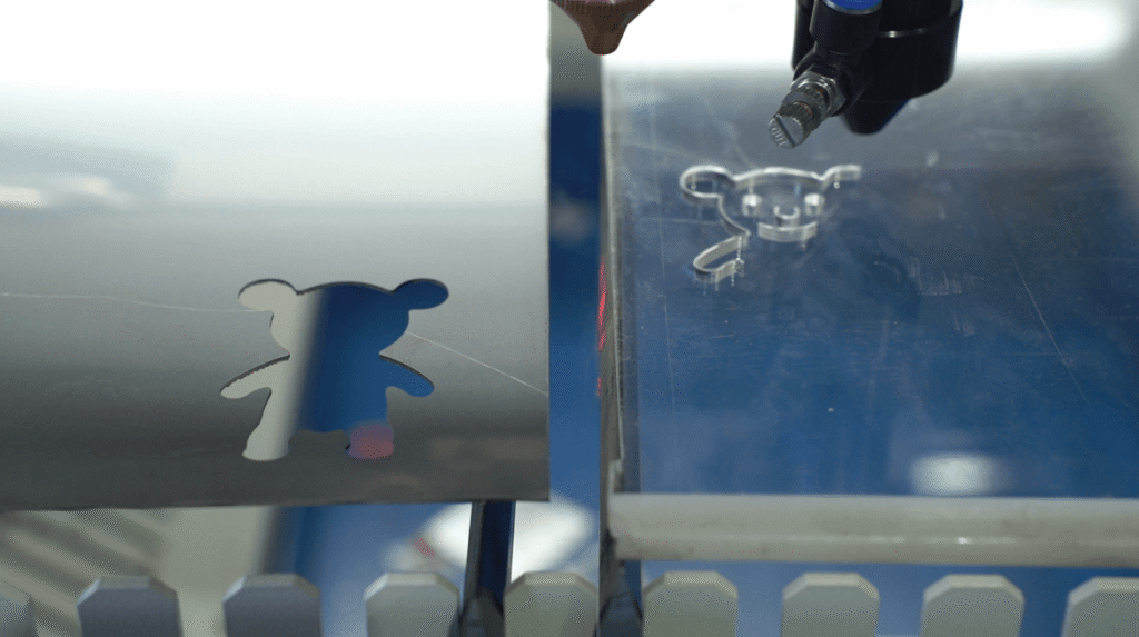 Laser cutting metal sheet process showing clean cut edges.