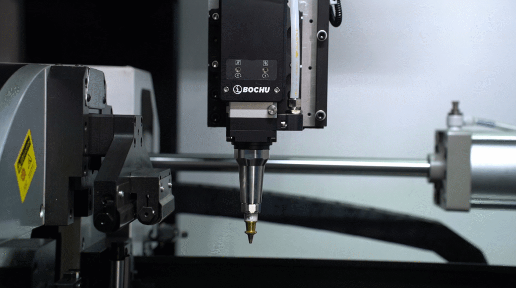 BOCHU laser cutting head on fiber laser pipe cutter, close-up of precision metal processing