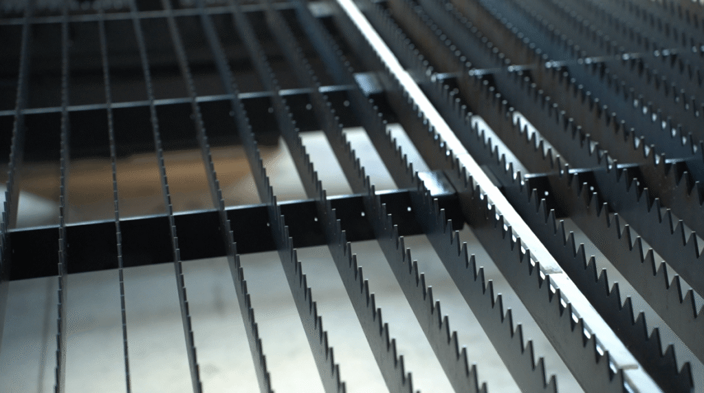 Heavy-duty serrated steel slats for laser bed.
