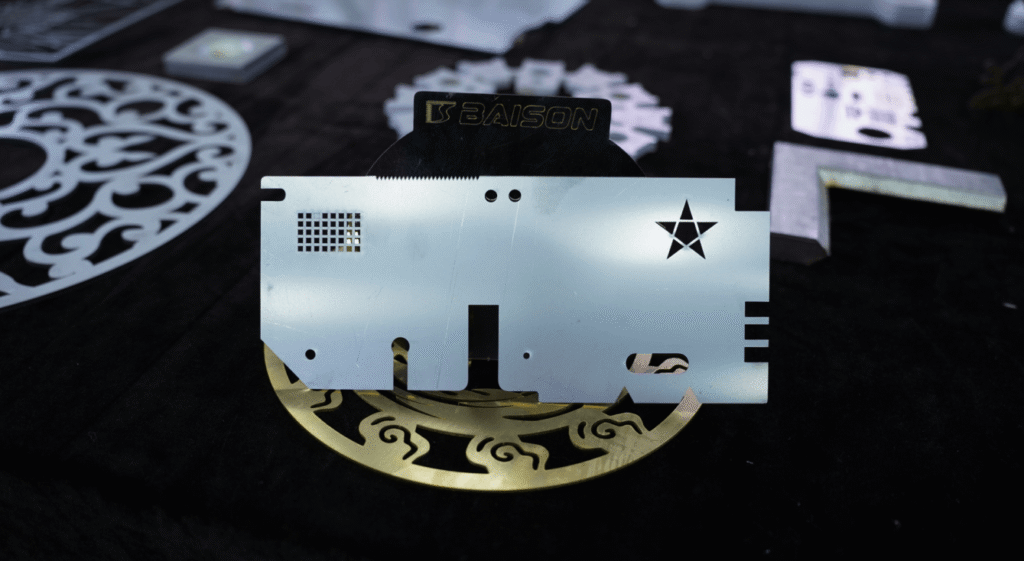 Clean burr-free laser cut metal part sample with Baison logo.