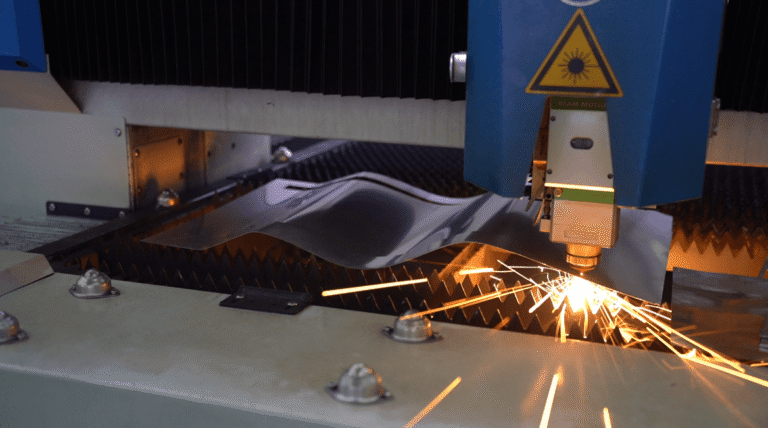 Fiber laser cutting machine processing metal sheet with sparks.