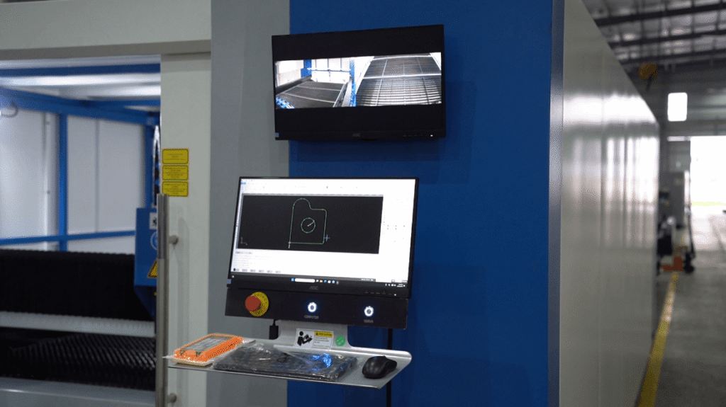 High-precision fiber laser cutting head during metal fabrication.