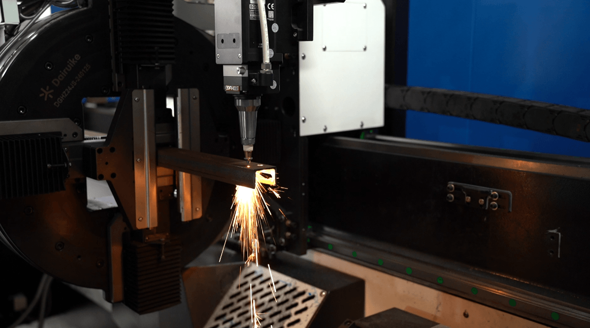 Close-up of a high-power fiber laser cutting head in operation.