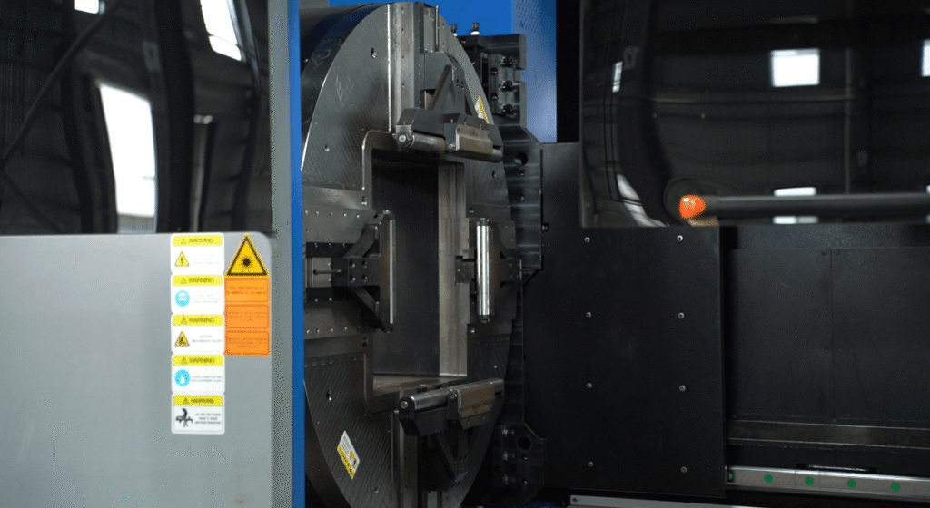 High-speed fiber laser cutting process with bright sparks.