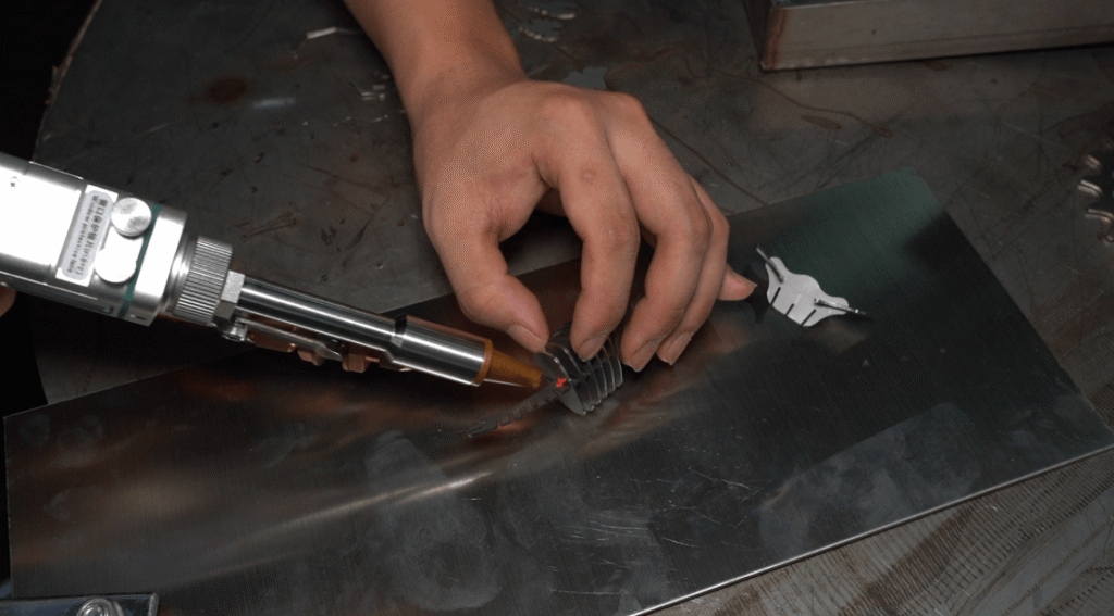Handheld laser welding machine precisely processing small hardware parts.