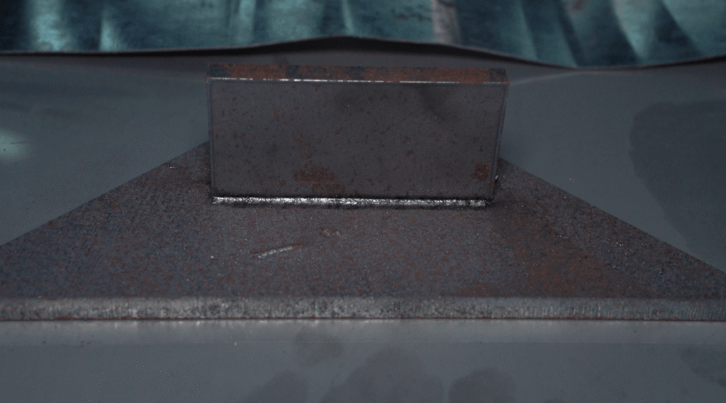 Strong weld seam on a thick carbon steel plate by an industrial laser welding machine.