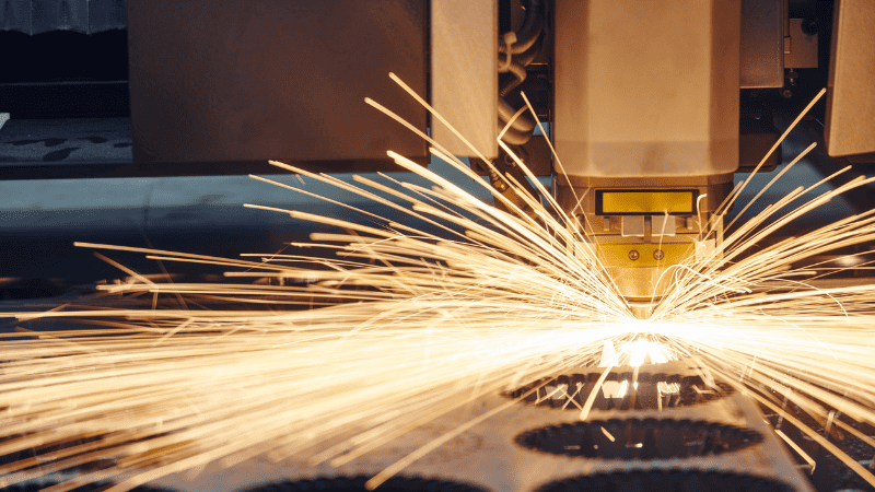 High-speed laser cutting with assist gas.