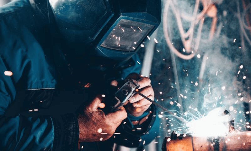 A welder is using a portable welder for the welding process.