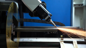 Baison laser bevel cutting head processing metal pipe with sparks.