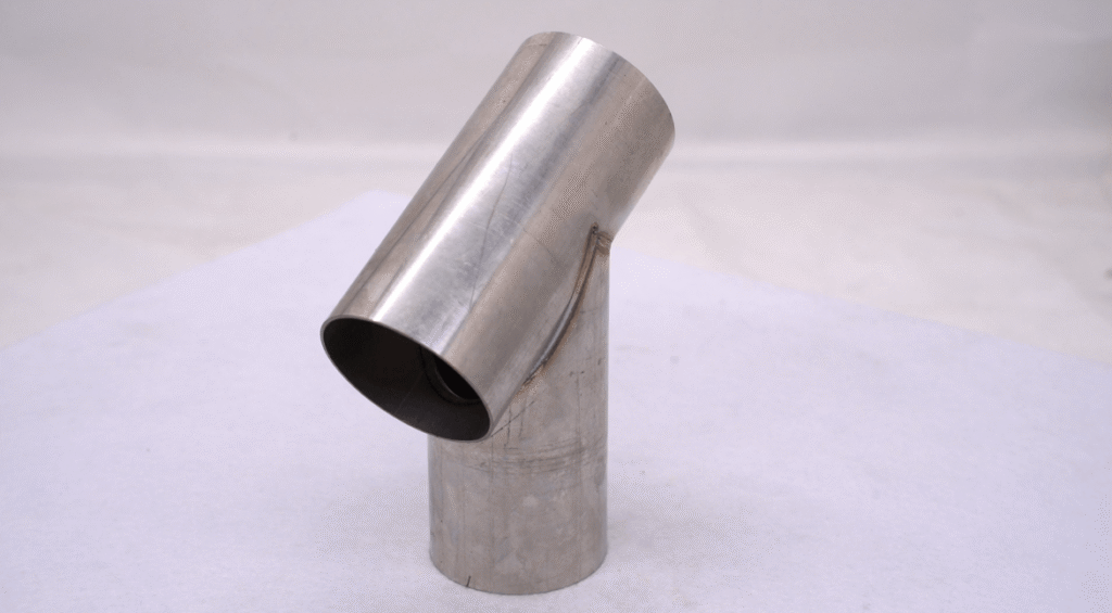 Welded stainless steel pipe elbow showing smooth single-pass seam.