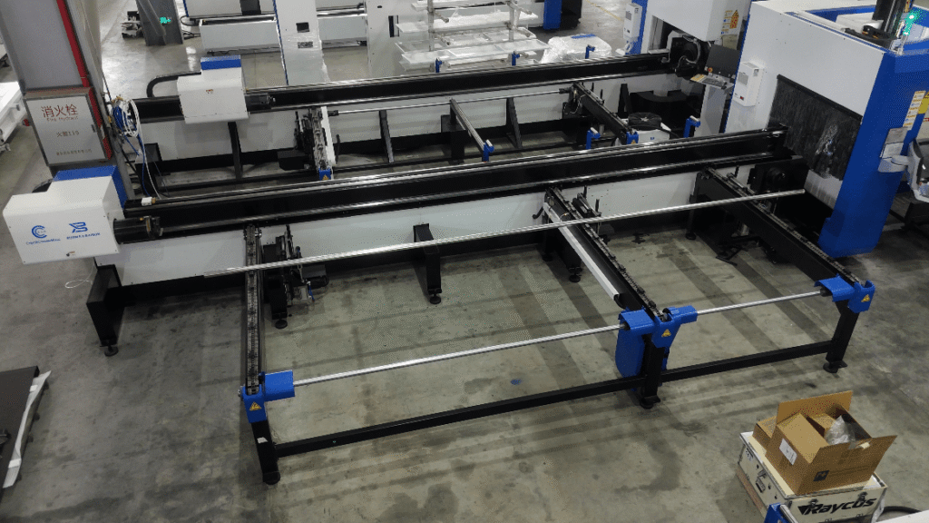 Laser pipe cutting machine loading bed in manufacturing factory.