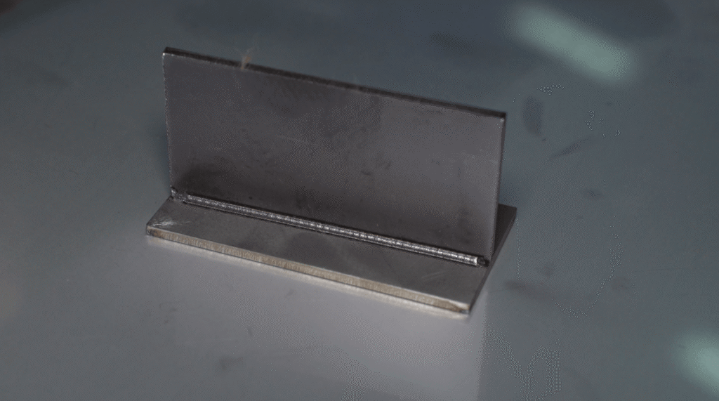 Finished T-joint weld sample with smooth, polish-free bead.