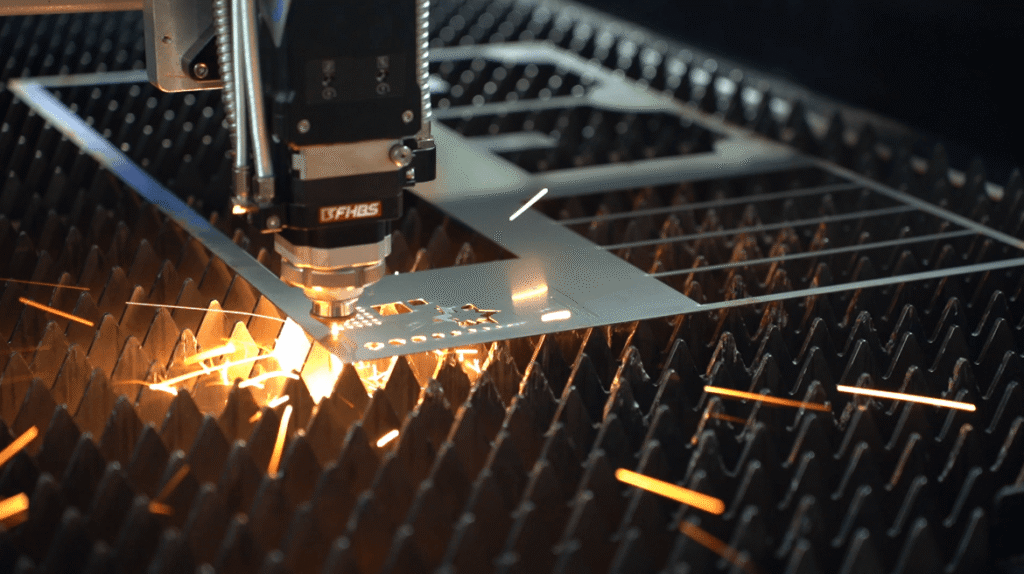 Tête de découpe laser haute puissance perçant une plaque d'acier de construction avec des étincelles.