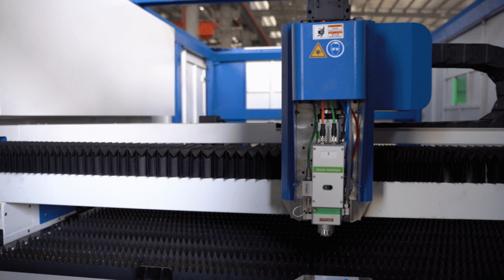Precision cutting head inside a flatbed laser cutter.