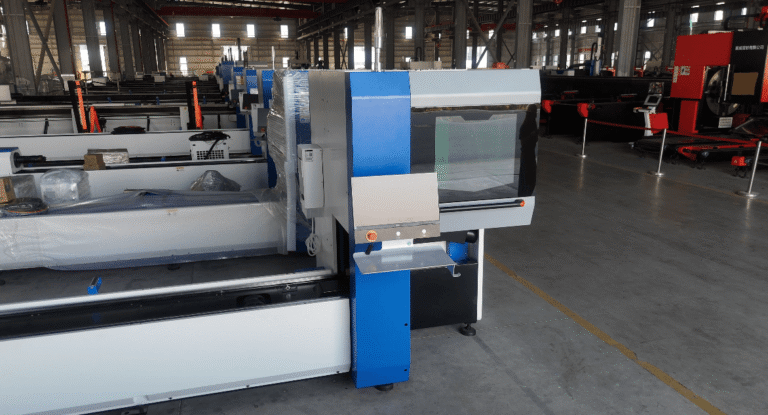 Laser cutting machine control station and protective enclosure.