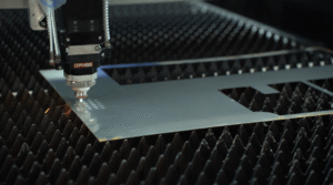 Fiber laser cutting head processing metal sheet edge precisely.