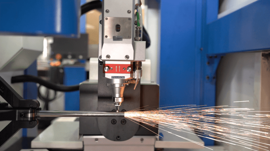 Laser cutting a thin metal tube with sparks flying.