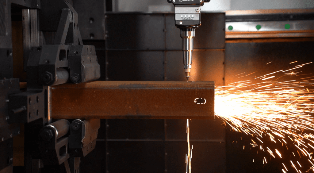 Laser cutting stencil precision slot on an industrial metal profile.