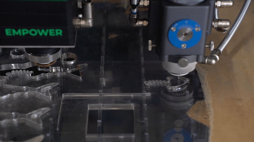 Laser cutting acrylic stencil pattern with precise dual heads.