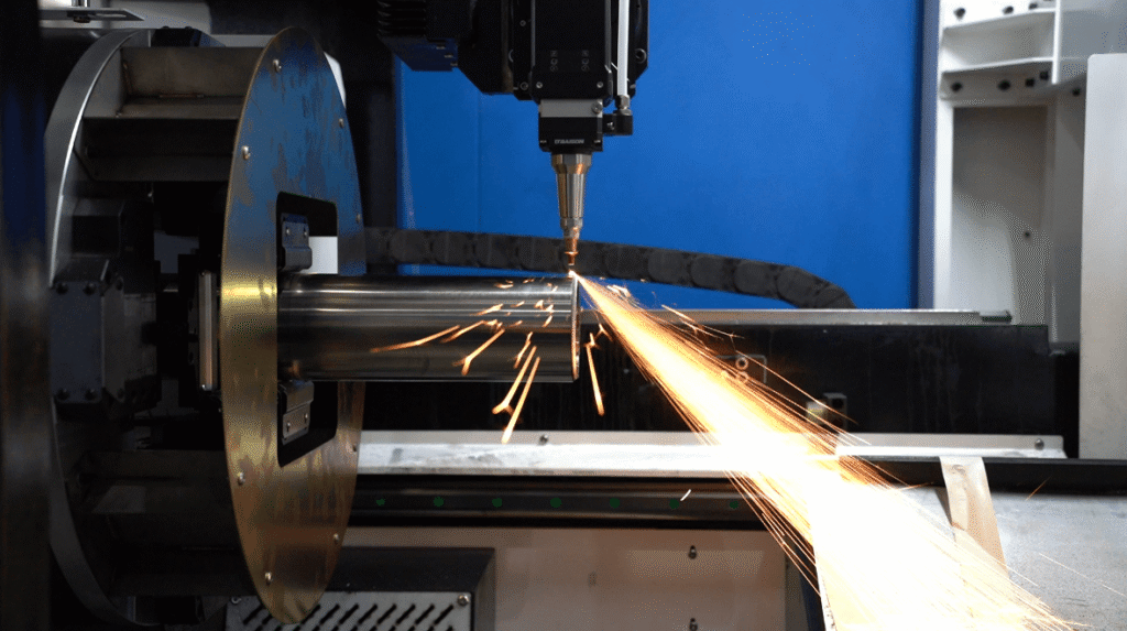 Laser beam cutting metal pipe with sparks.