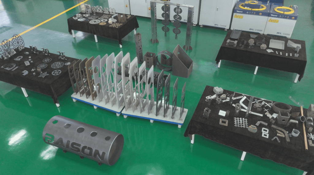 Finished metal parts cut by a Baison fiber laser displayed on tables.