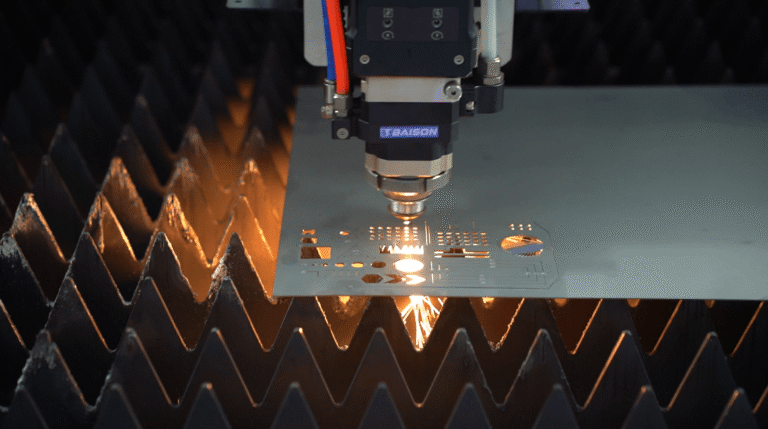Laser cutting head processing a metal sheet with sparks.