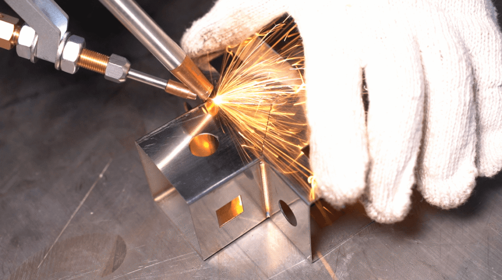 Precision laser welding square tubes with sparks.