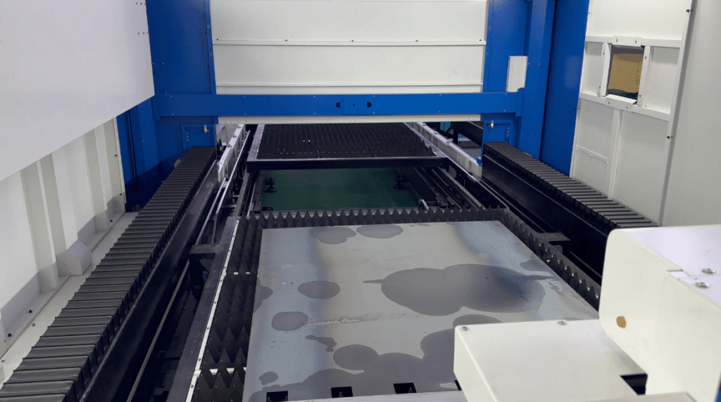 Internal view of a fully enclosed laser cutting bed.