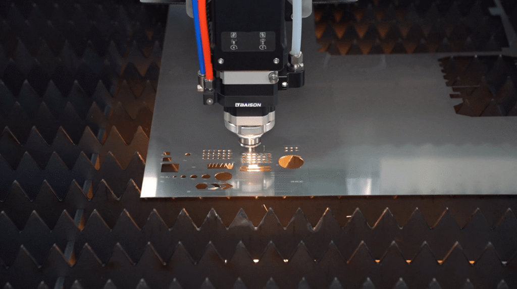 Top view of laser cutting geometric patterns on steel.