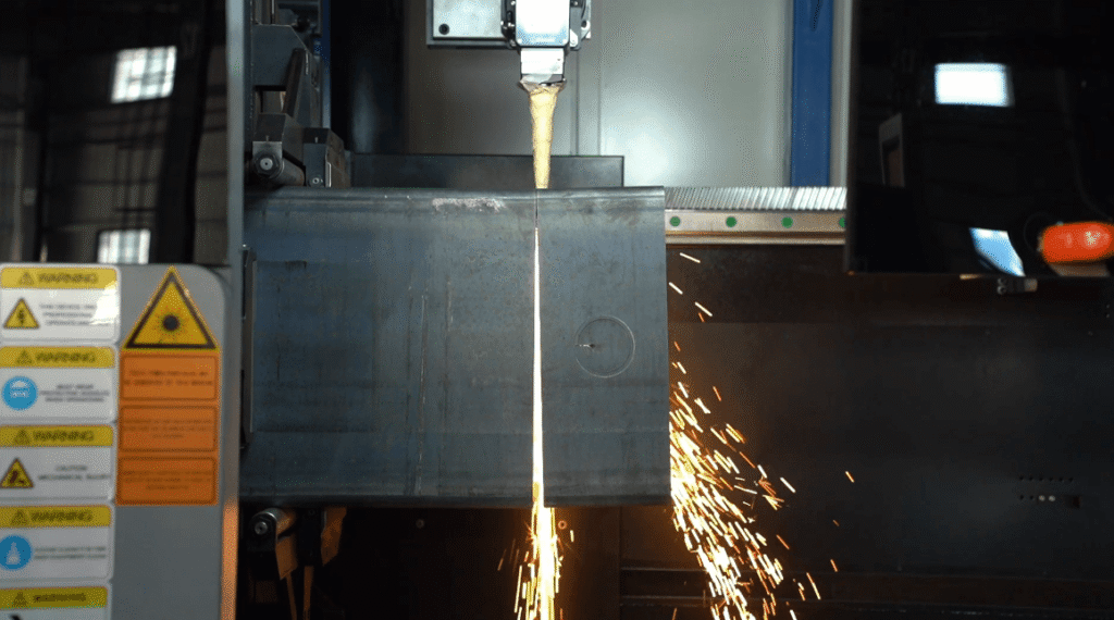 Laser tube cutting machine slicing metal pipe.