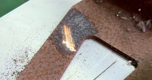 Baison Laser Rust Removal: Laser beam precisely removes rust from metal sheet.