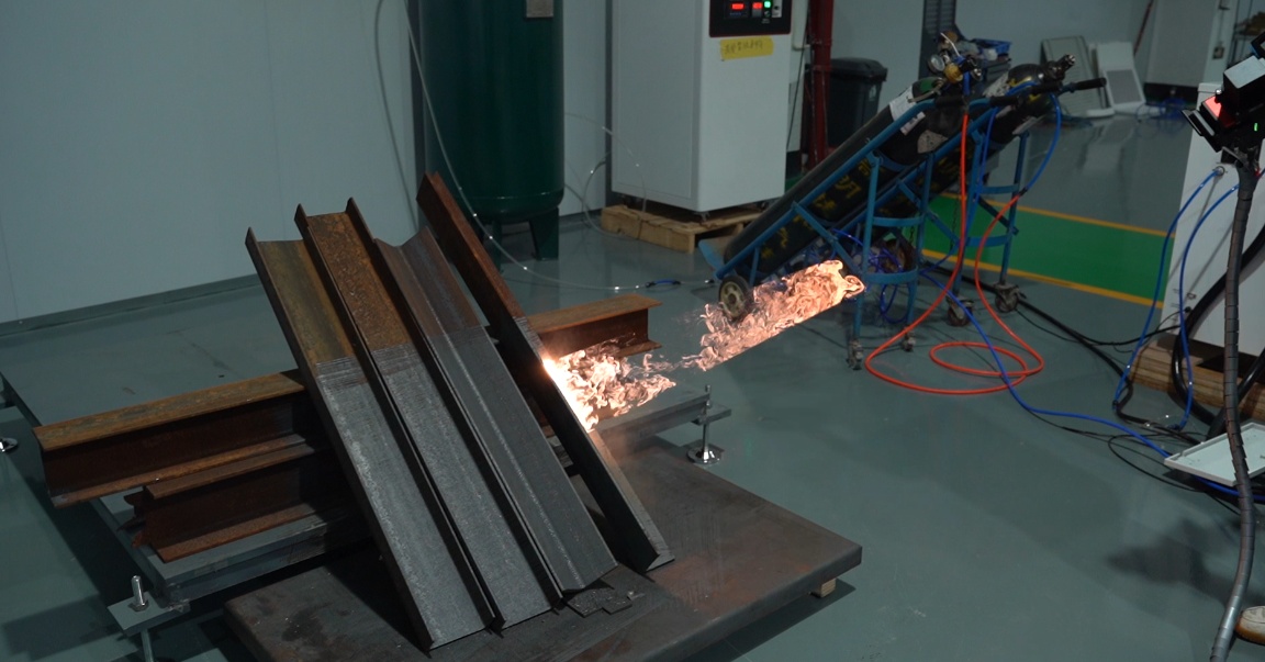 Baison laser rust removal on steel I-beams, creating sparks and flames