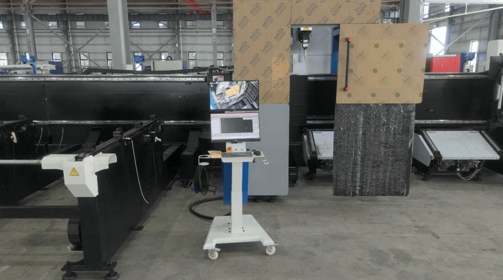 Side view of laser cutting machine housing and cable track.