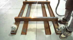 Laser cleaning rust off a steel beam.
