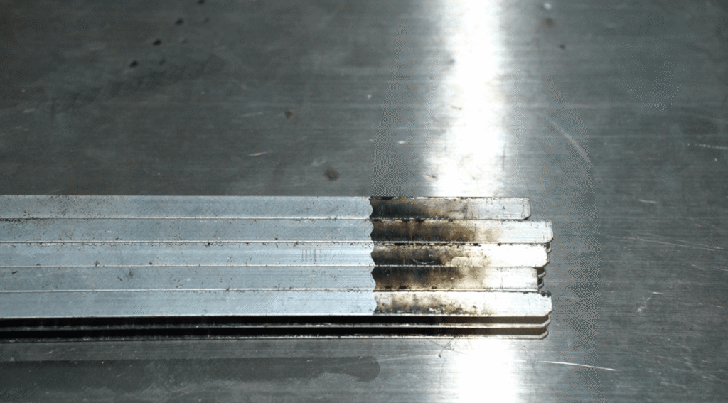 Before and after comparison of laser oxide removal on metal strips
