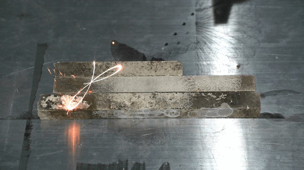 Pulsed laser stripping heavy rust and welding slag from industrial steel.