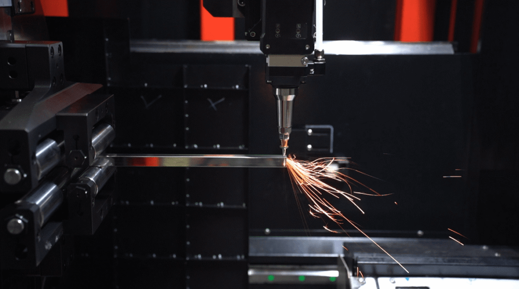 Laser head cutting metal tube with sparks