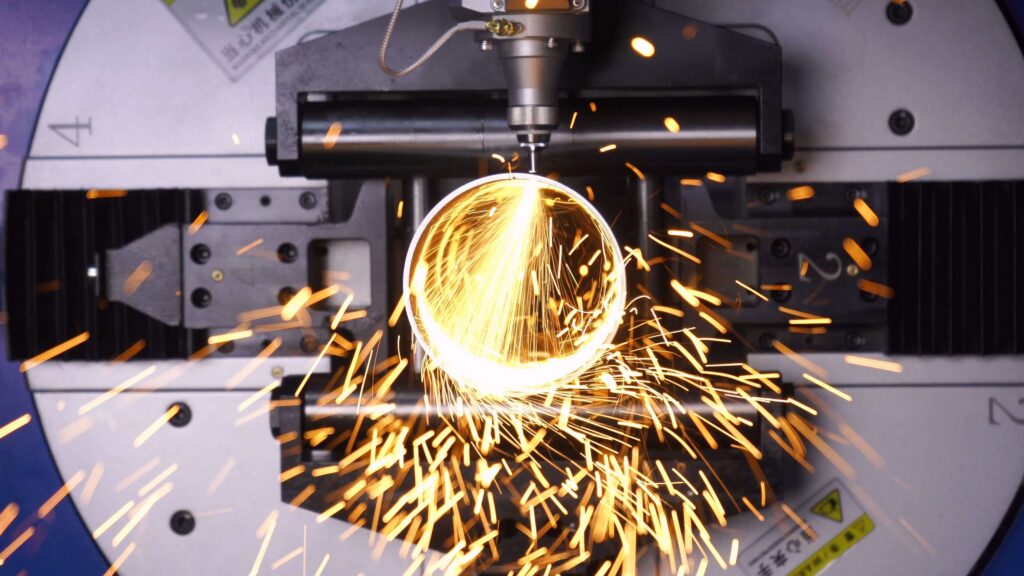 Fiber laser cutting sparks on metal pipe chuck