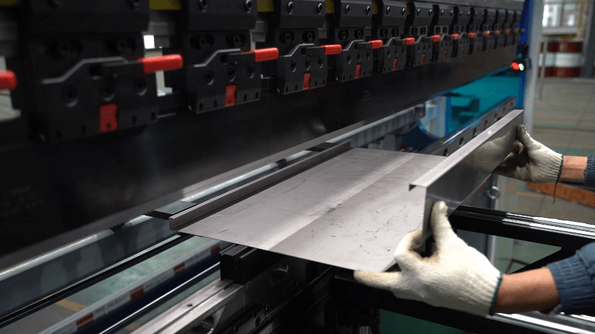 Operator bending HVAC sheet metal components on a Baison CNC press brake for high-precision enclosure assembly.