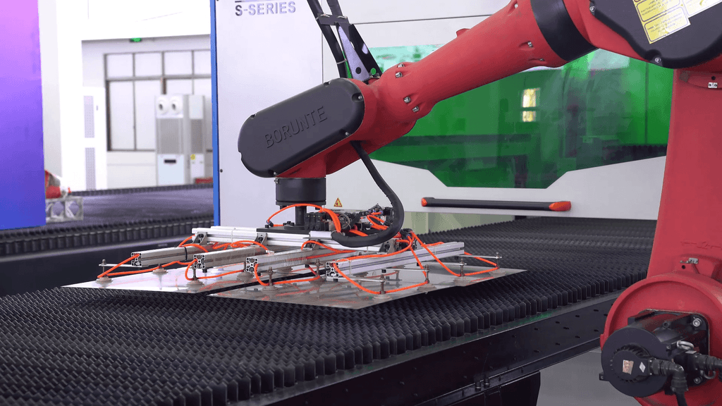 Automated robotic unloading system for BAISON SJC3 coil fed laser cutting machine.