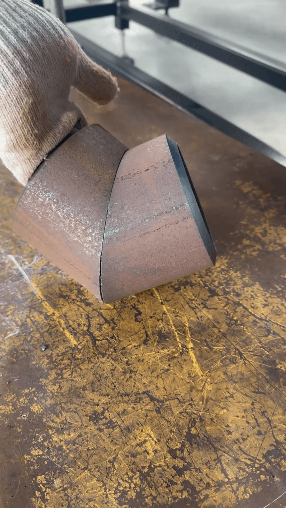 Precision bevel-cut steel pipes aligned with zero-gap fit-up for welding.